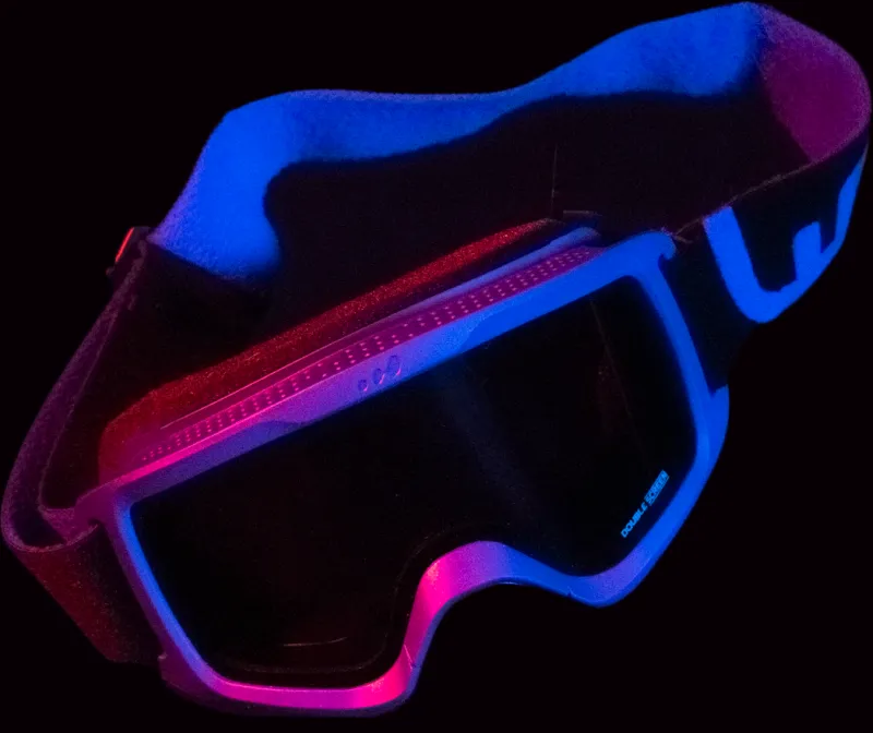 Render of the goggles lit blue and magenta, three-quarter view
